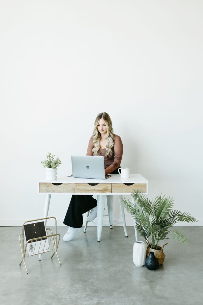 Karly Whitaker at desk using laptop