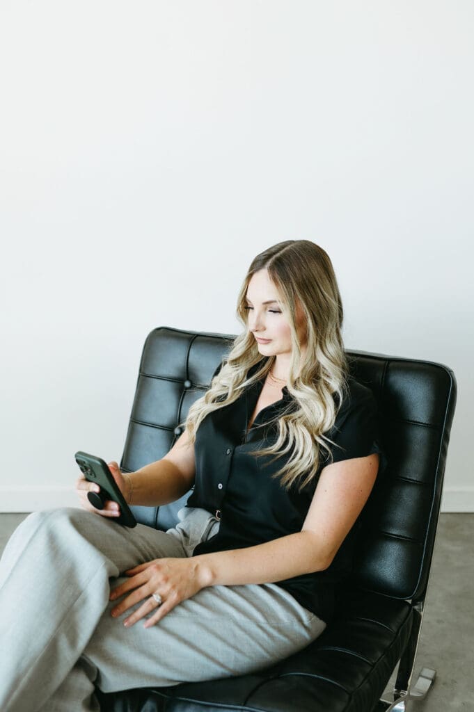 Karly Whitaker using HoneyBook on her mobile phone