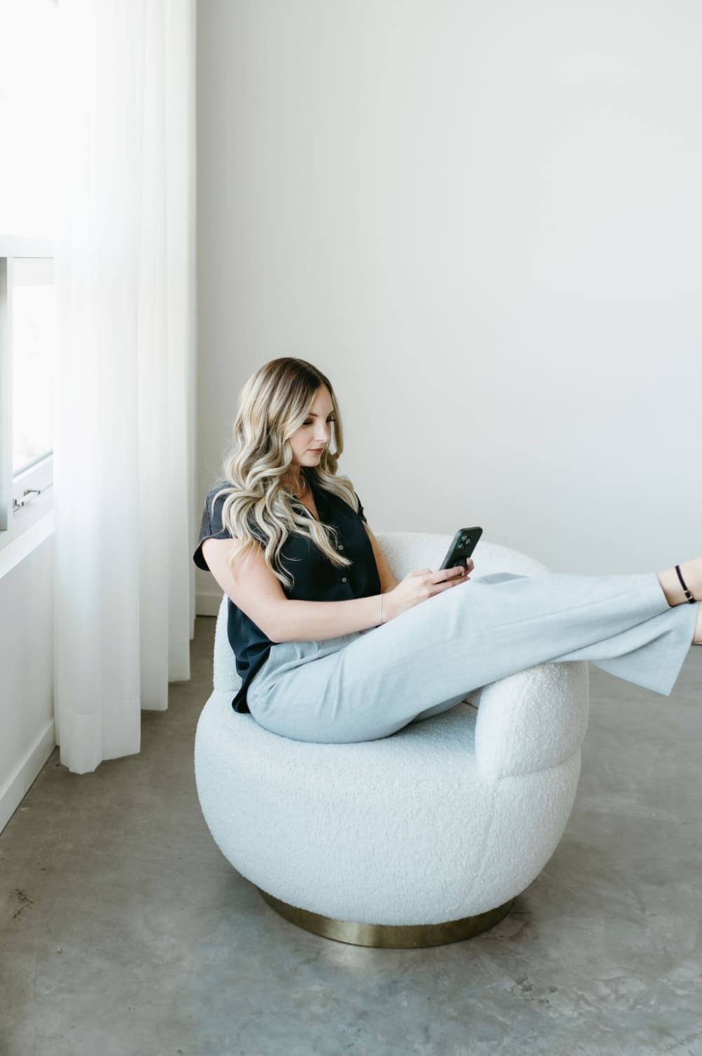 Business owner managing client communication and automated workflows from her phone using Zapier with HoneyBook integration.