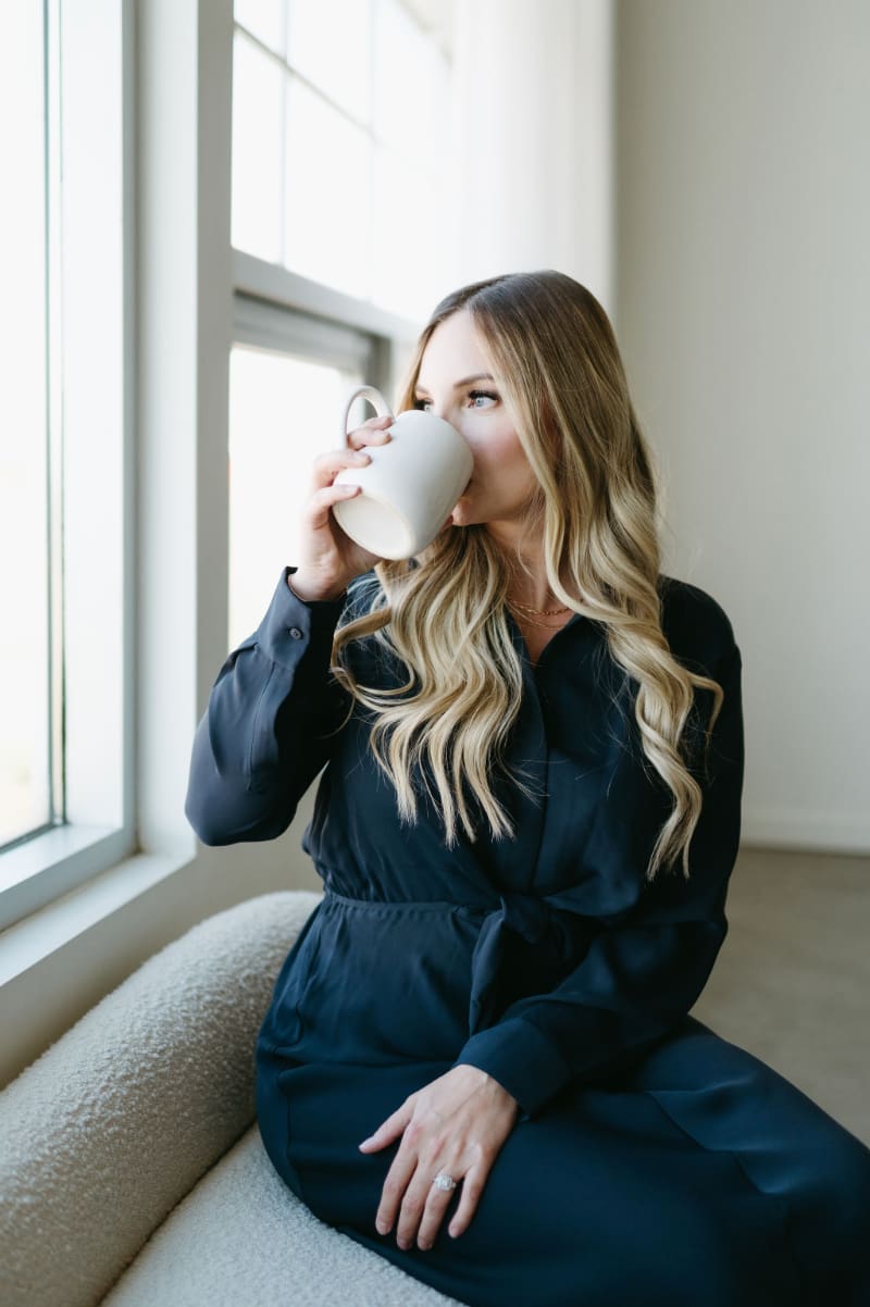 Karly Whitaker taking a coffee break while helping creative entrepreneurs simplify their HoneyBook systems